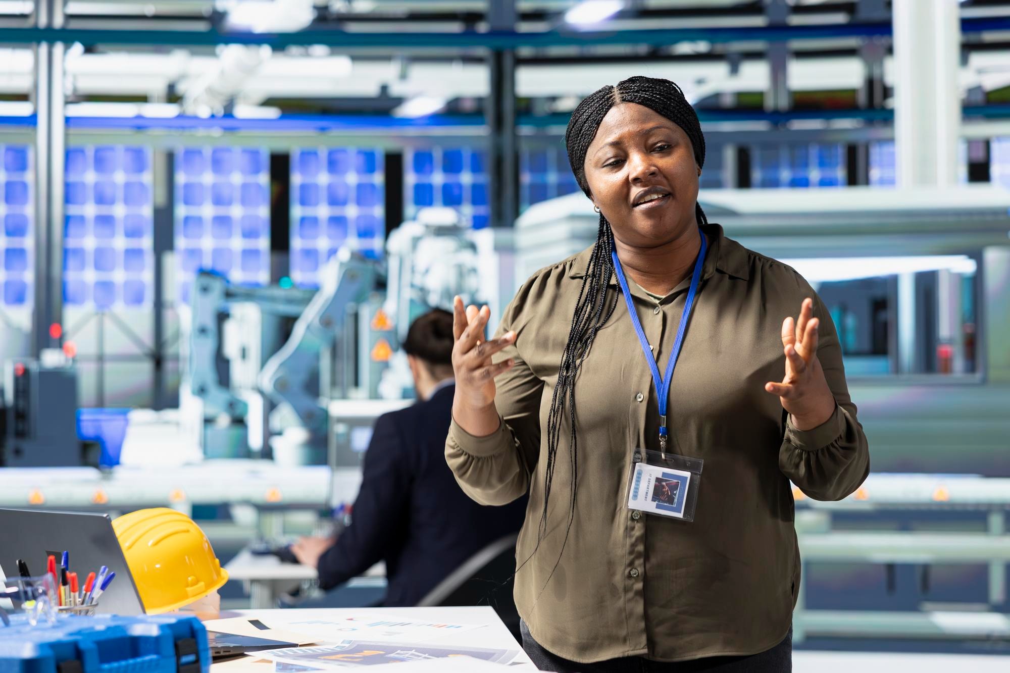 African industrial leader presenting inside a production facility