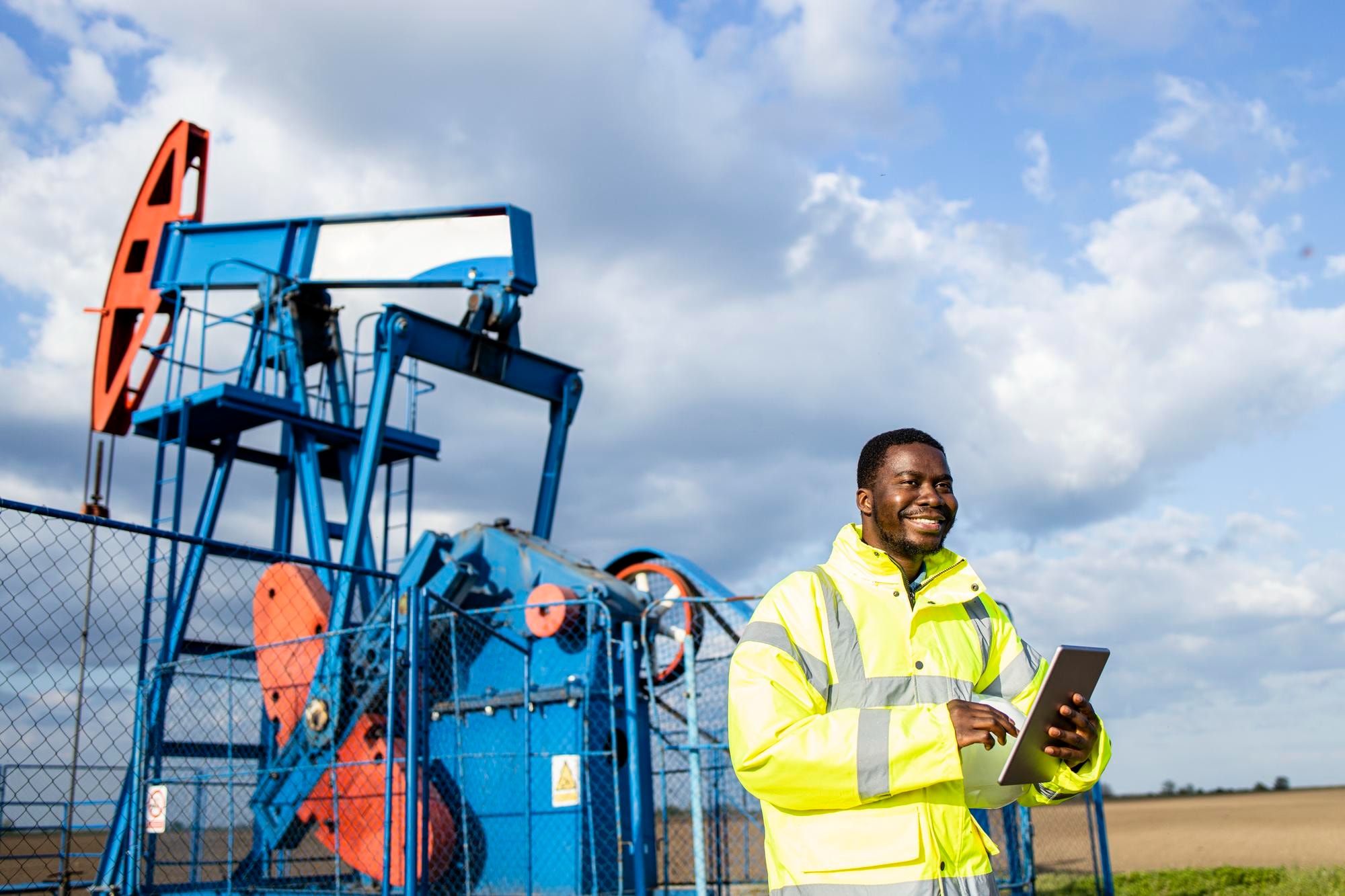 African energy professional working beside production infrastructure